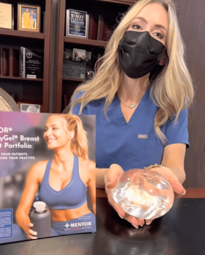 Female doctor holding a breast implant