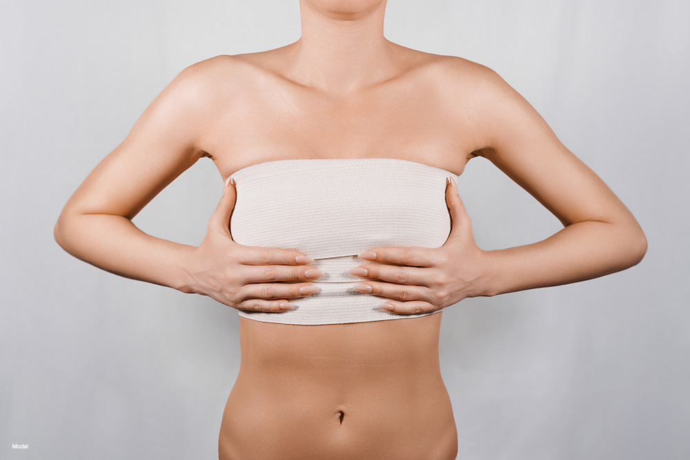 Woman with bandages over her breasts